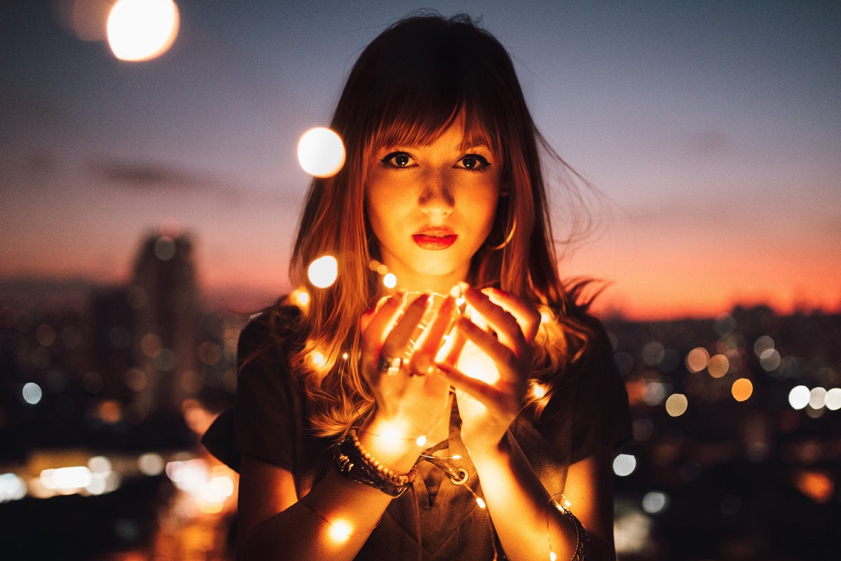 young woman holding string of lights innovation creativity digital transformation by matheus bertel